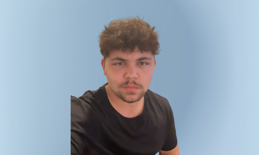 Photo of Treysyn in front of a faded blue background.