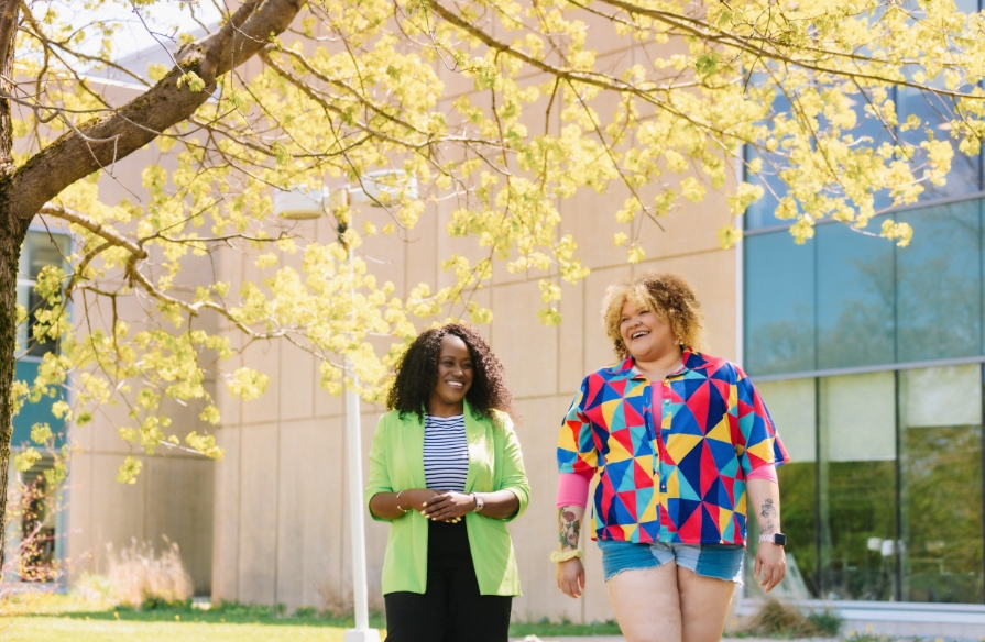Photo of NSCC student and employee on campus on a nice sunny day.