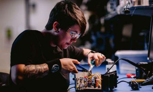 Photo of Alicia Montague working on electrical wires.