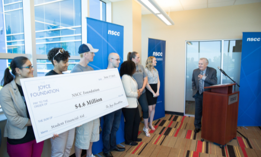 Photo of donor Ron Joyce offering his wisdom to past NSCC award recipients