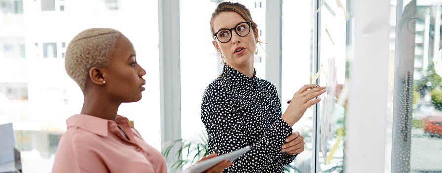 Female colleagues work on a project at the office