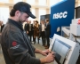 Student working on a computer terminal below an NSCC sign.