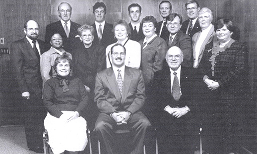 Large group photo of men and women in professional attire