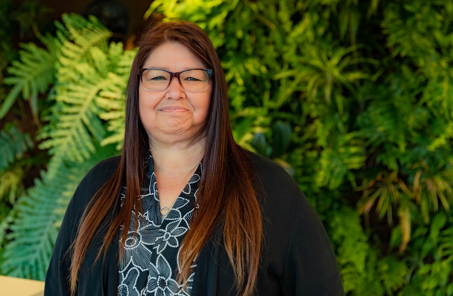 Marie Dutka, Faculty at NSCC, stands facing the camera and smiling.