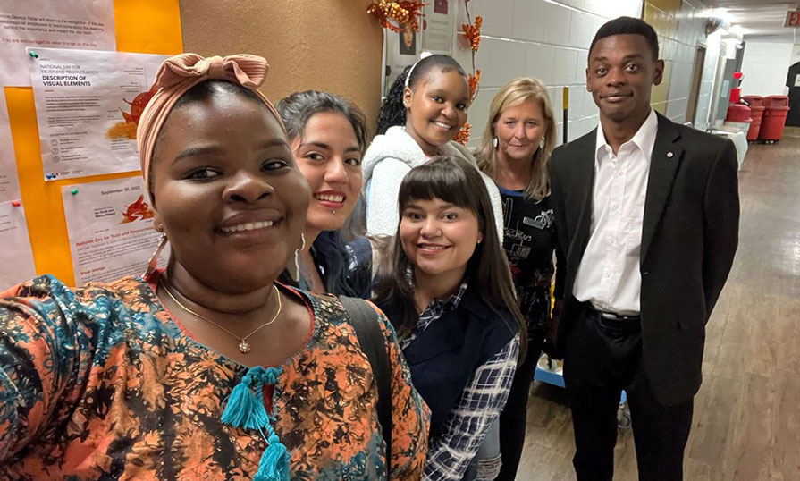 A group of students takes a selfie.