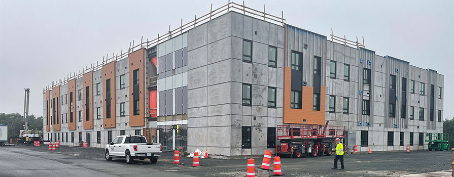 A construction site is shown of a new student housing facility being built.