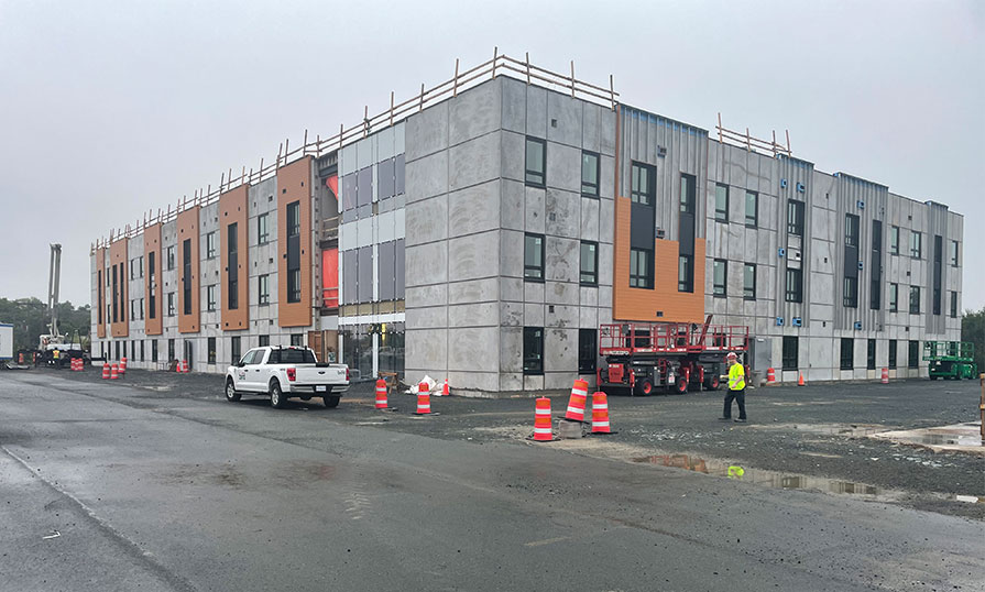 A construction site is shown of a new student housing facility being built.