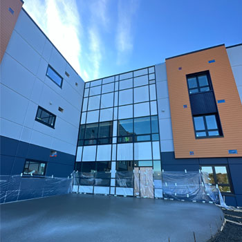 Image shows the outside of a new building being built.