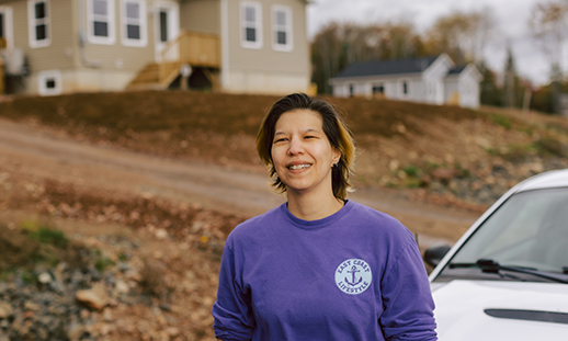 April Googoo, standing in a subdivision in Wagmatcook where she and her uncles are building houses.