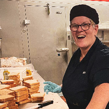 Employee preparing sandwiches in a kitchen