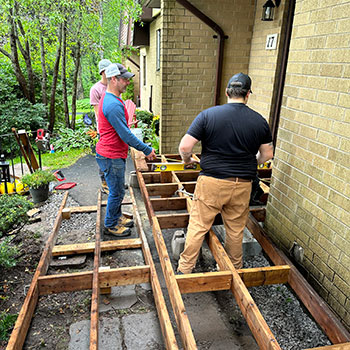 Instructor demonstrating how to install the upper landing of an accessibility ramp.