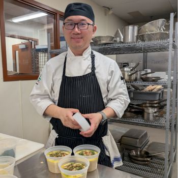 Image shows a student in a chef uniform.
