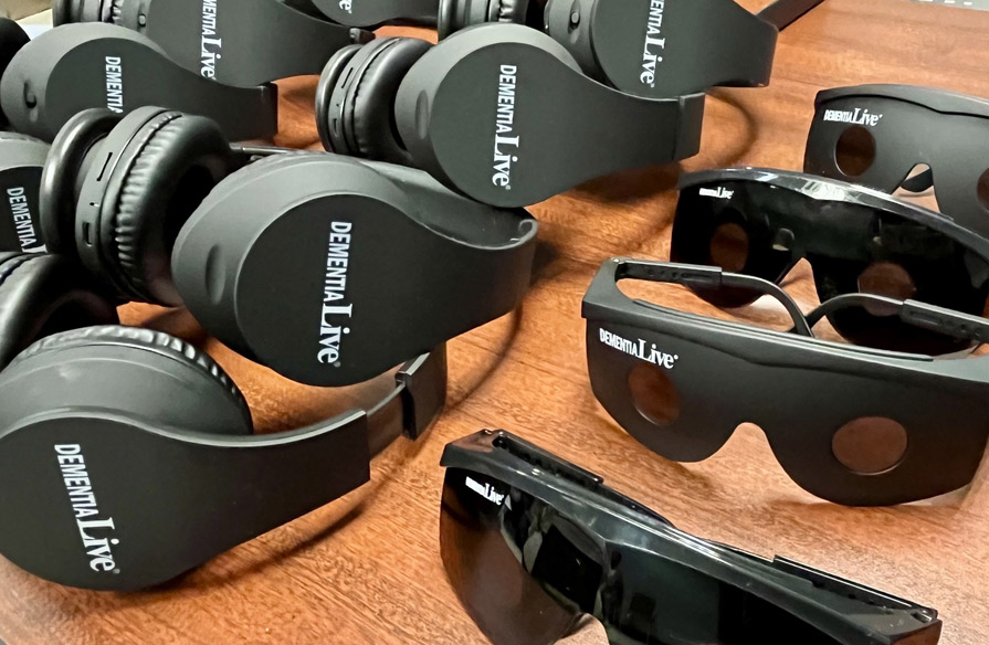 Image shows headphones and dark glasses that are part of the Dementia Live simulation.