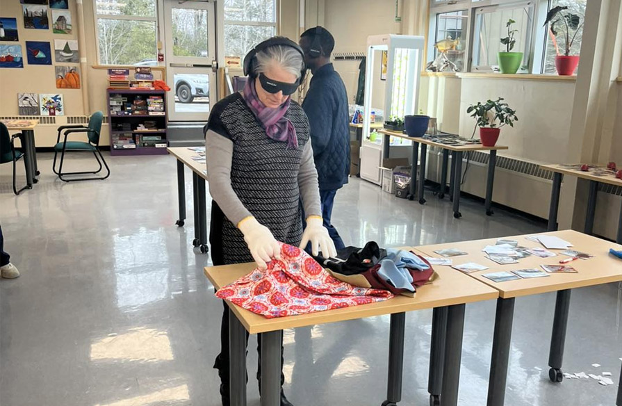 A CORAH member takes part in the Dementia Live simulation, attempting to complete every day tasks.