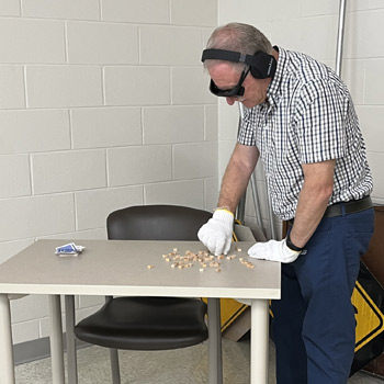 A CORAH member takes part in the Dementia Live simulation, attempting to complete every day tasks.