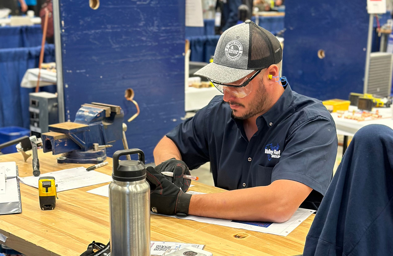 A person is working on measurements during a competition.