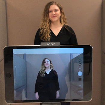 ASL/English interpretation students use technology like Ipads to record themselves during class time to practice interpretation skills.