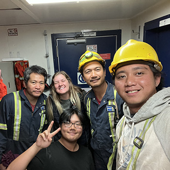Olivia and four of her crewmates pose for a picture inside the ship.