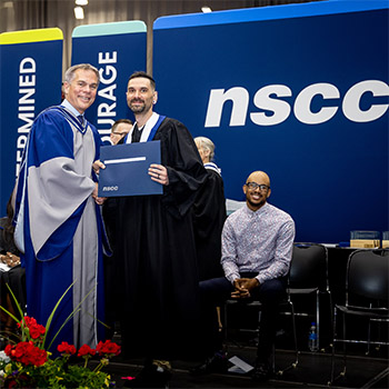 Shaun poses with NSCC President Don Bureaux as he's handed his diploma.
