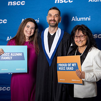 Shaun poses with his family in a photo booth.