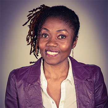 A headshot of a person wearing a purple blazer.