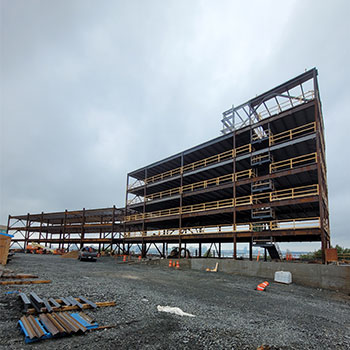 A construction site is shown of a new student housing facility being built.