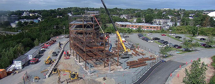A drone shows an overhead view of a steel building structure.