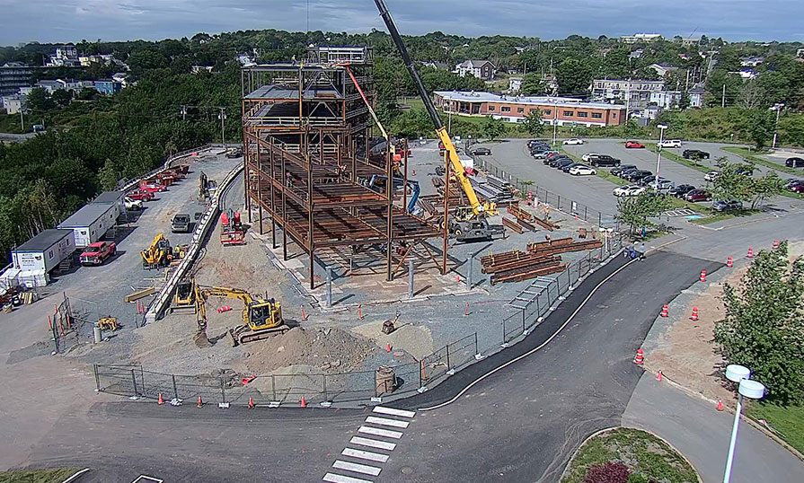 A drone shows an overhead view of a steel building structure.