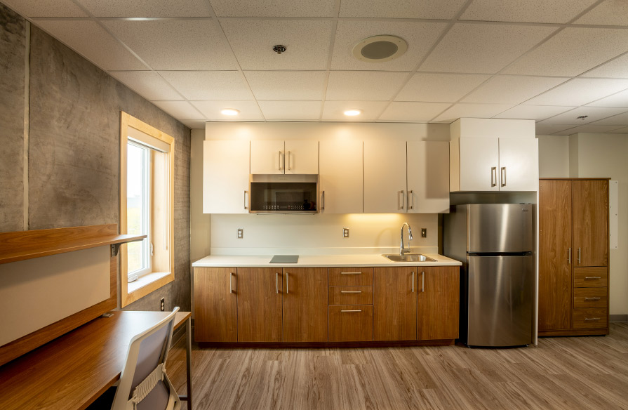 Image shows the kitchen area of a new dorm room at NSCC Ivany Campus student housing.