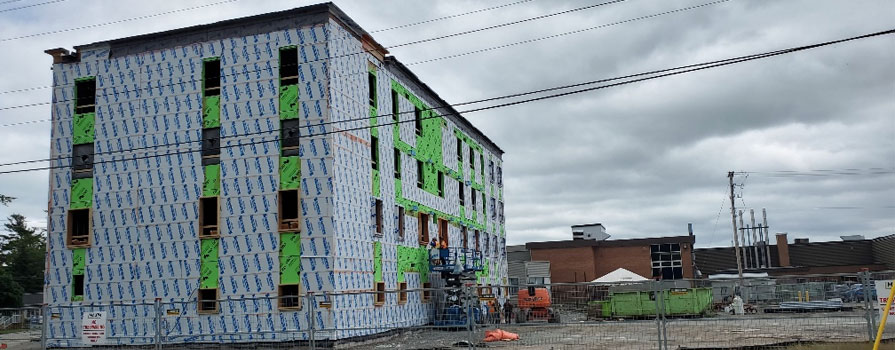 A construction site shows a multilevel building under construction.