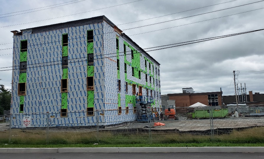 A construction site shows a multilevel building under construction.