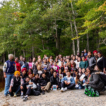 NSCC Tourism and Hospitality students gathered together on a beach at Kejimkujik National Park