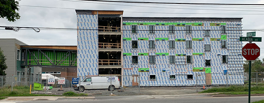 A construction site is shown of a new student housing facility being built.