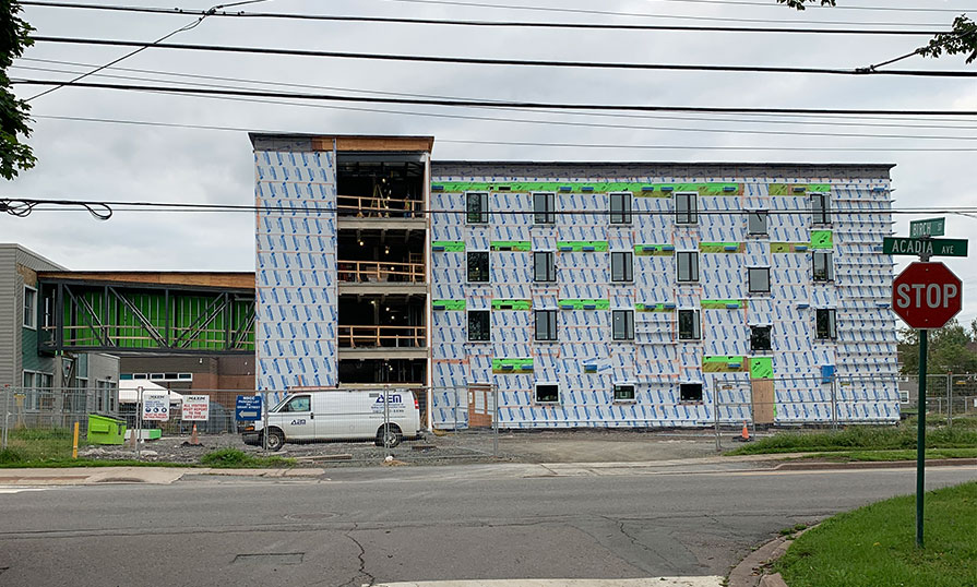 A construction site is shown of a new student housing facility being built.