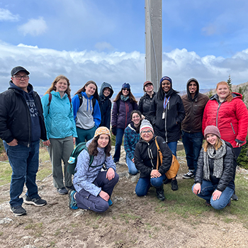 A group of people posing outdoors. 