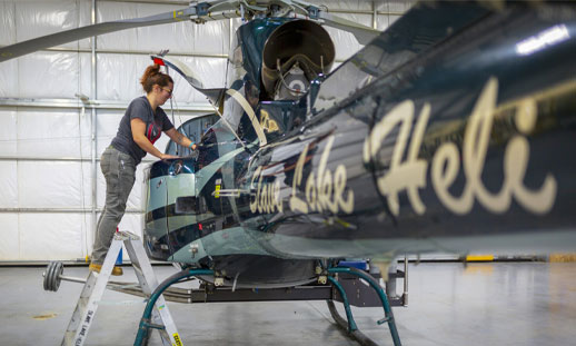 A person is working on an airplane. 