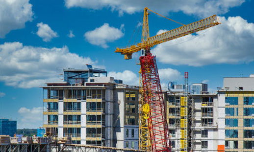 Image shows new buildings under construction and a few cranes. 