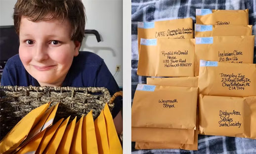 A child smiles with a bunch of envelopes of Christmas cards ready to go to the mail.