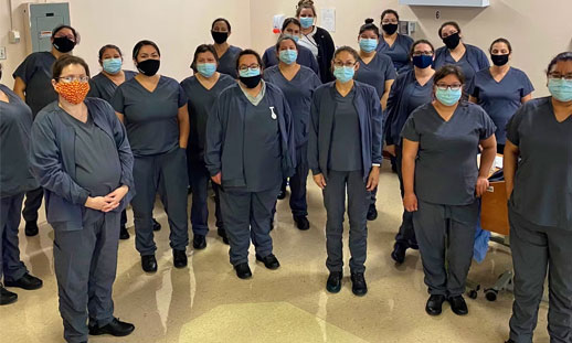 A group of continuing care assistants stand together for a photo.