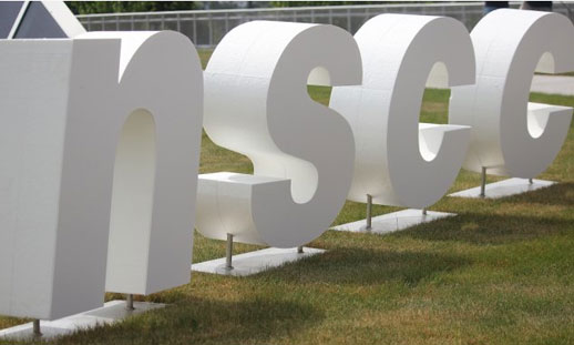 3d letters spell NSCC on a lawn.