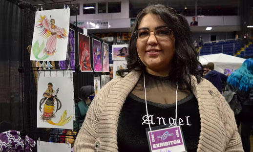 Hailee McDonald, who uses the artist name Tsekwichoghart, stands beside her booth at CaperCon 2022 in Sydney. Behind her are some of her Indigenous mermaids which are McDonald's original designs. NICOLE SULLIVAN / CAPE BRETON POST - Nicole Sullivan