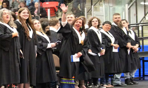 A group of grads are standing together, celebrating at NSCC Marconi Campus.