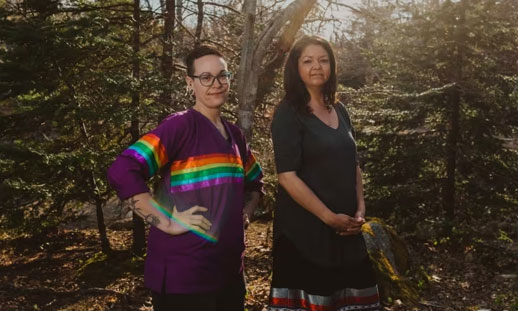 Mi'kmaw signers Holly Green and Sheila Johnson are pictured. They are outside in a sunny forest.