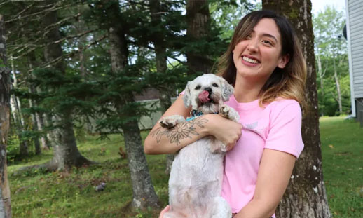 Tyra Paul, creator of Drip Avenue 902, holds her dog wowkwis. (Erin Pottie/CBC)