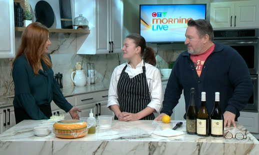 Three people are in a kitchen and talking.