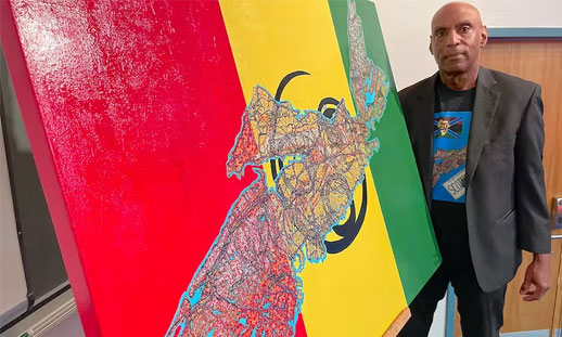 A man stands beside a large painting.