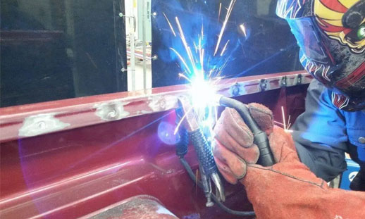 Photo shows someone welding.
