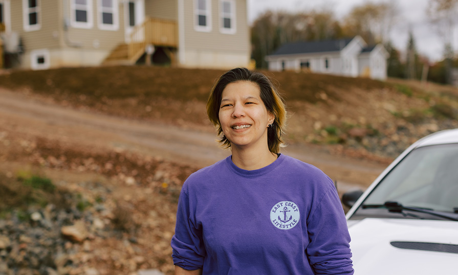 April Googoo, standing in a subdivision in Wagmatcook where she and her uncles are building houses.