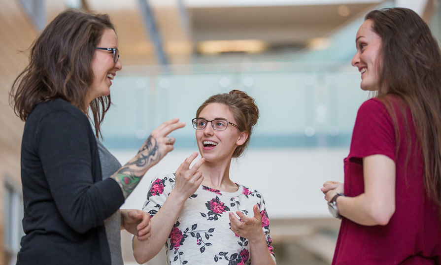 Three ASL students chatting at Ivany Campus.