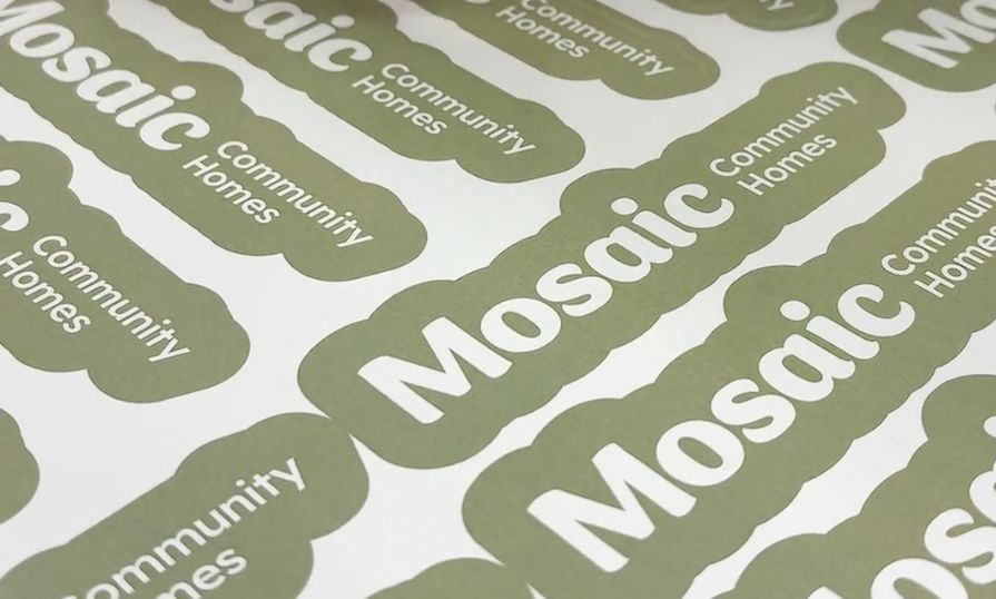 Green stickers are shown that say 'Mosaic Community Homes.'